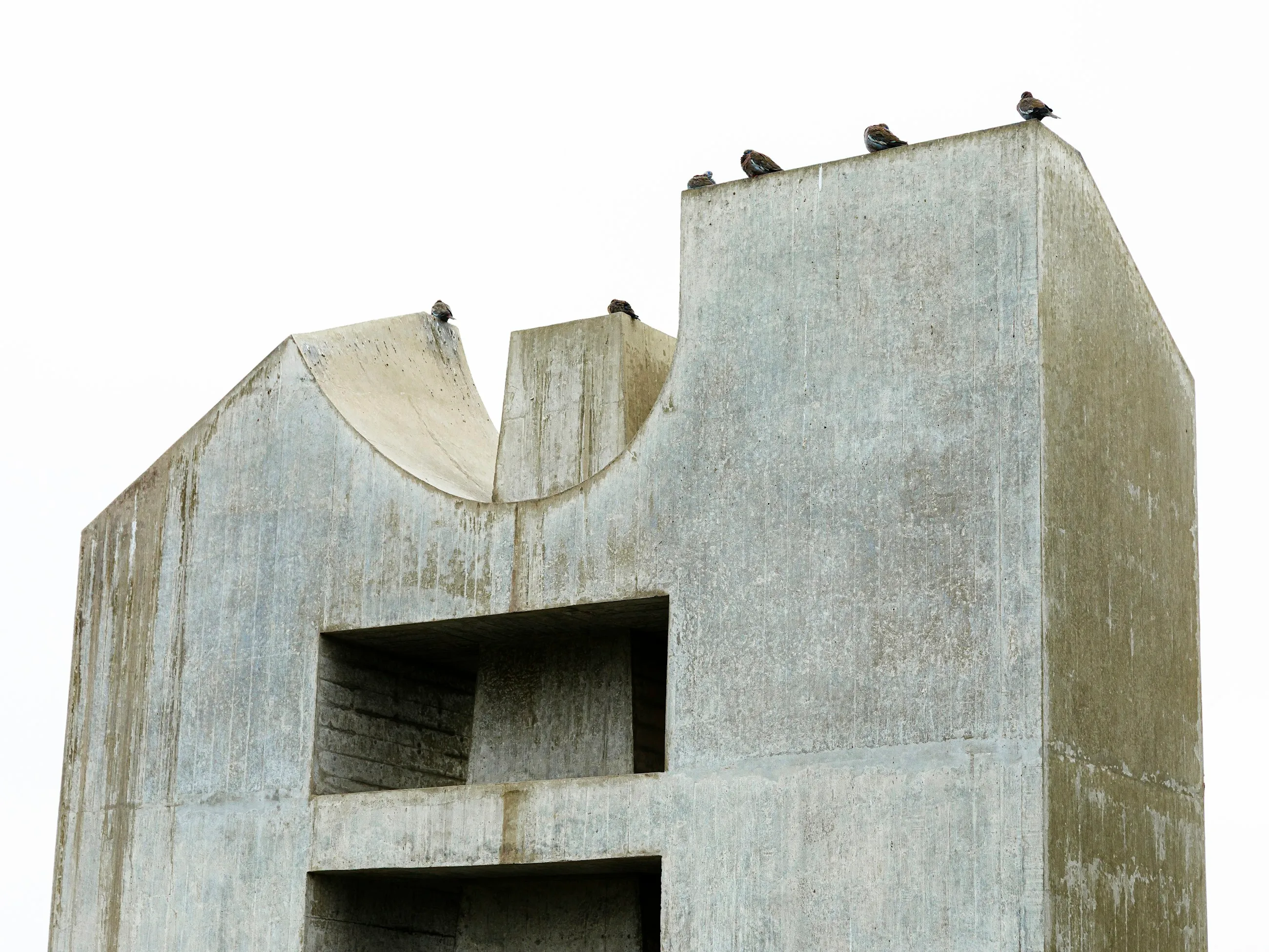 A board-marked concrete form standing against a pale sky.